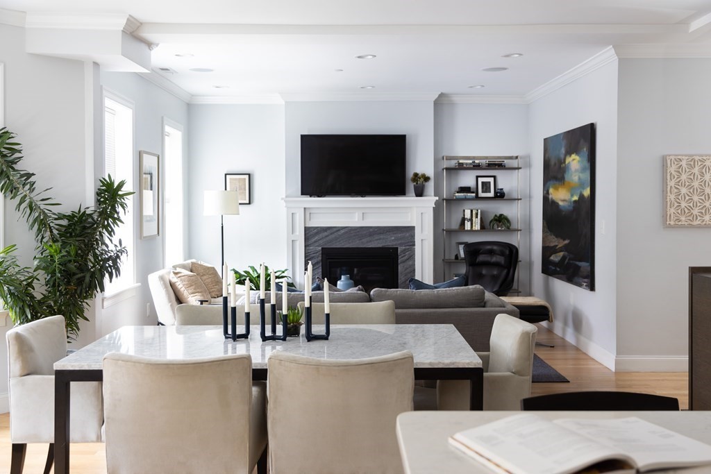 177 Winthrop Road, Unit 3 Brookline, MA 02445 - Photo 2 of 22 a living room with furniture a flat screen tv and a fireplace