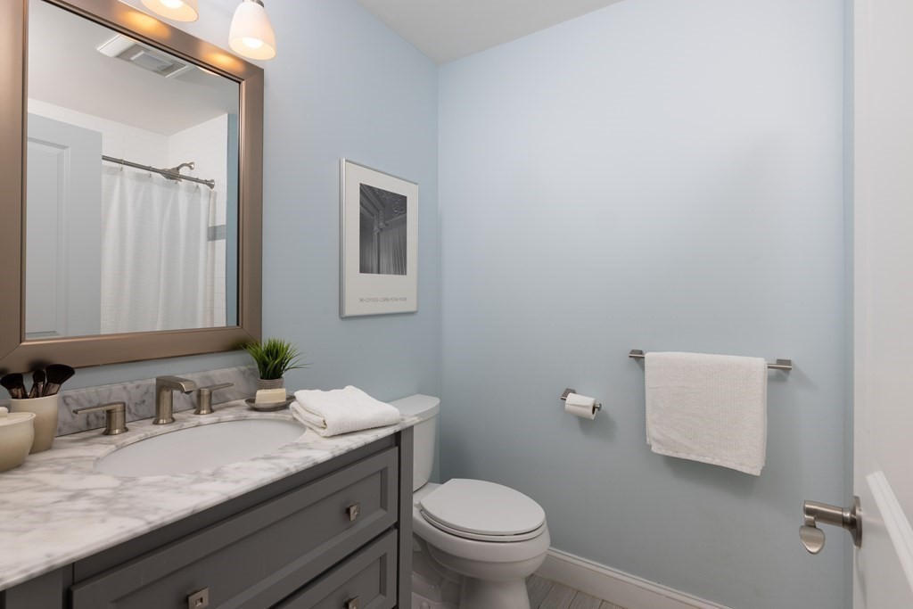 177 Winthrop Road, Unit 3 Brookline, MA 02445 - Photo 10 of 22 a bathroom with a granite countertop sink and a toilet