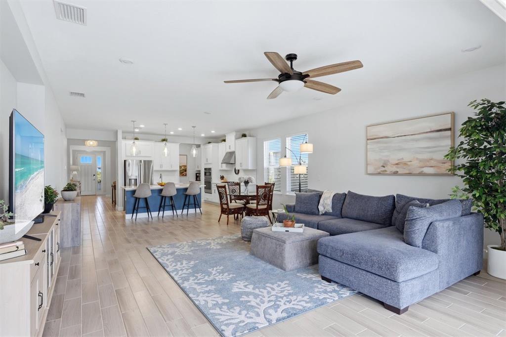 9268 Tequila Sunrise Drive Sarasota, FL 34241 - Photo 12 of 56 a living room with furniture and a wooden floor