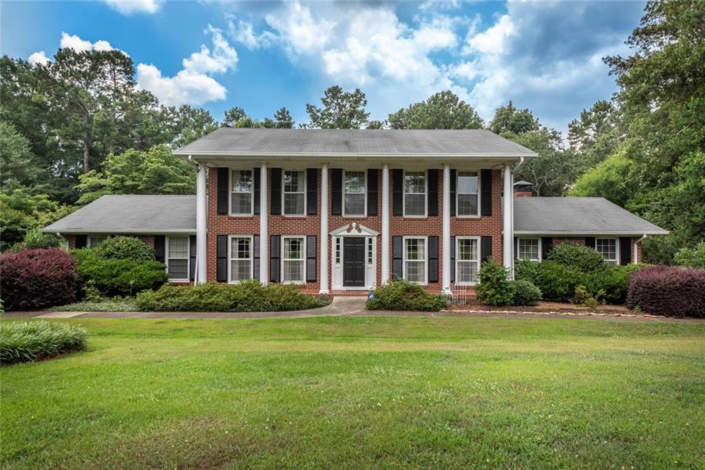 733 North Booth Road Northwest Kennesaw, GA 30144 - Photo 1 of 1 a front view of a house with a garden