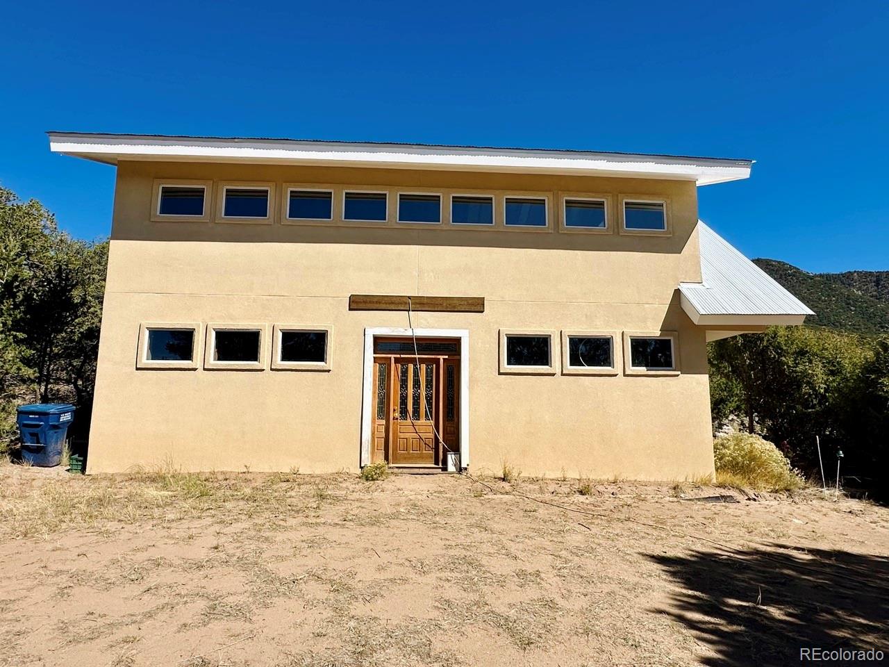 1751 Summitview Way Crestone, CO 81131 - Photo 12 of 50 a front view of a house with a yard