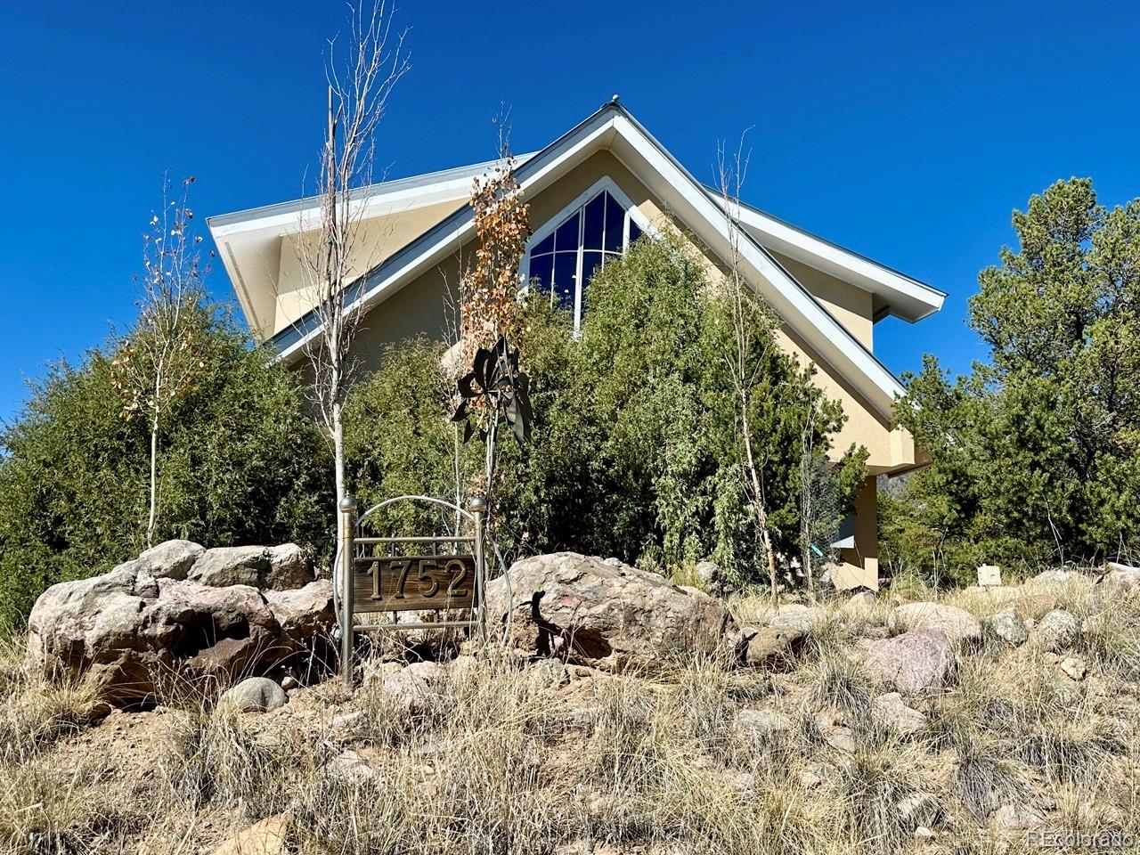 1751 Summitview Way Crestone, CO 81131 - Photo 4 of 50 a front view of a house with a yard