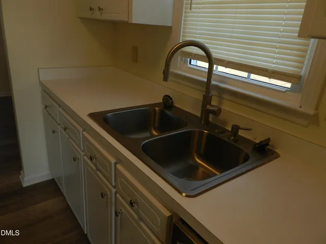 a close view of a sink and a refrigerator