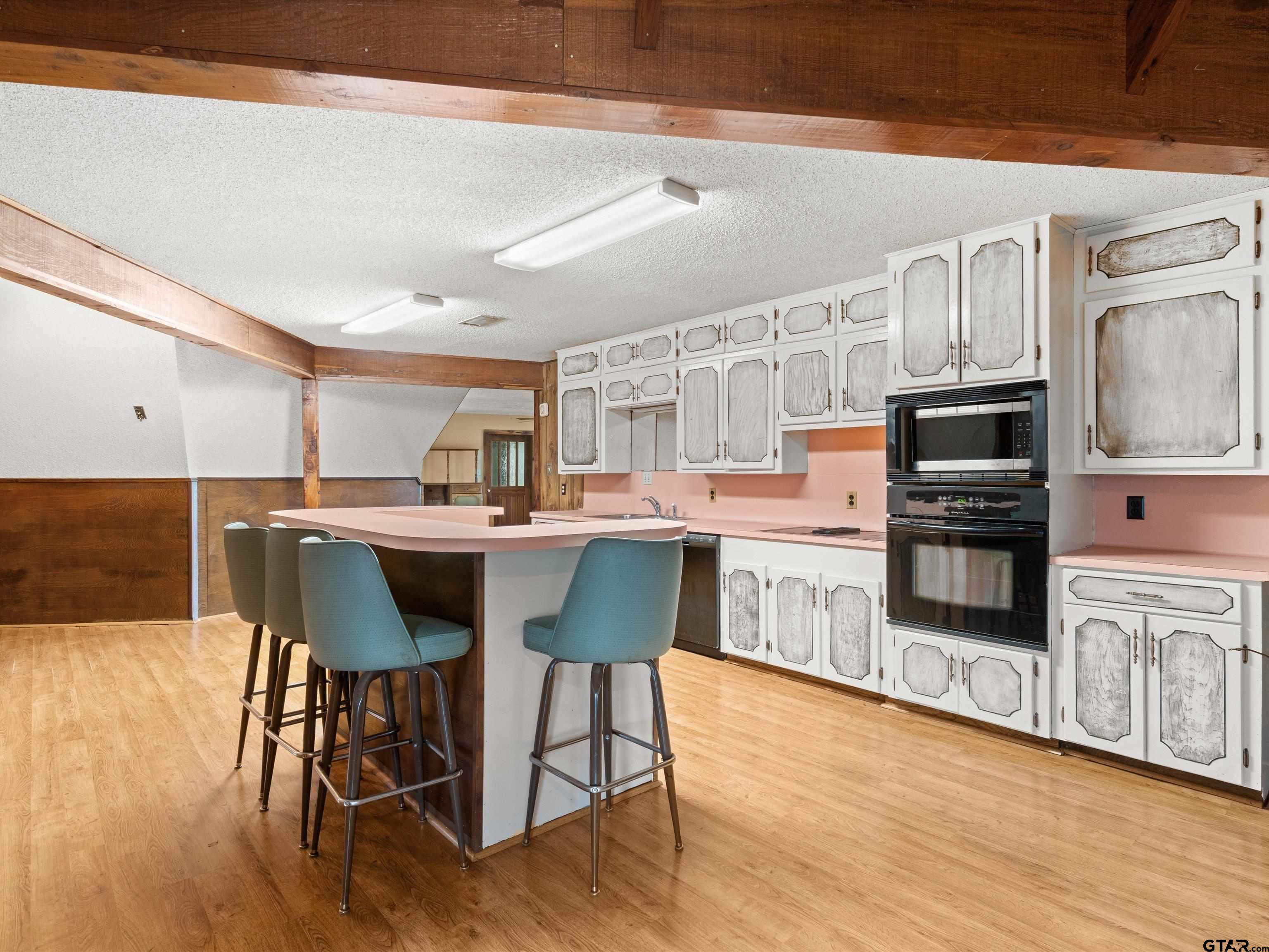 637 County Road 3201 Daingerfield, TX 75638 - Photo 13 of 33 a kitchen with stainless steel appliances a dining table chairs microwave and sink