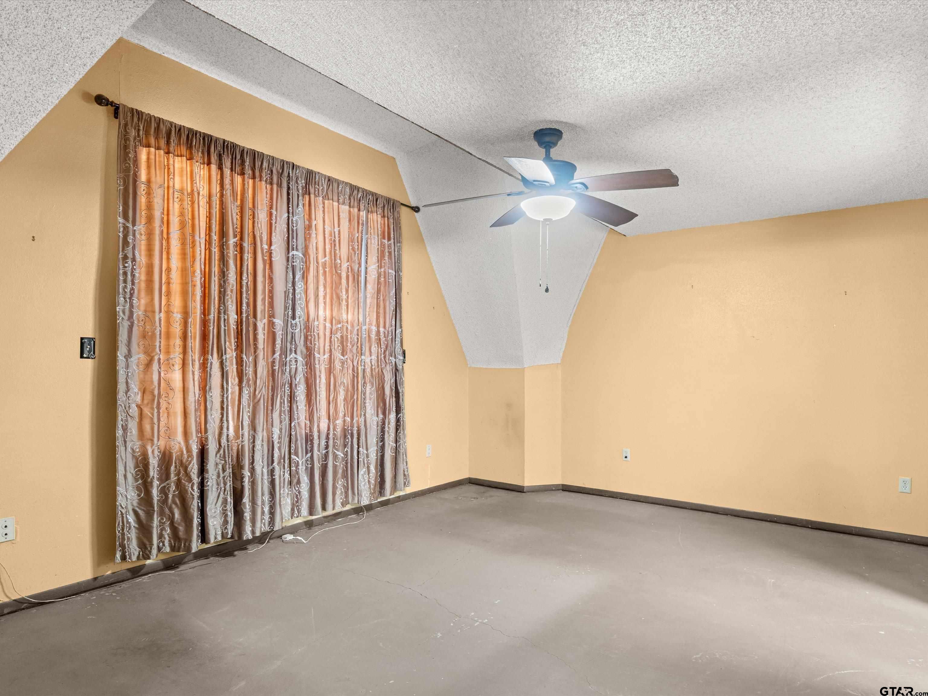 637 County Road 3201 Daingerfield, TX 75638 - Photo 19 of 33 an empty room with a ceiling fan and a window