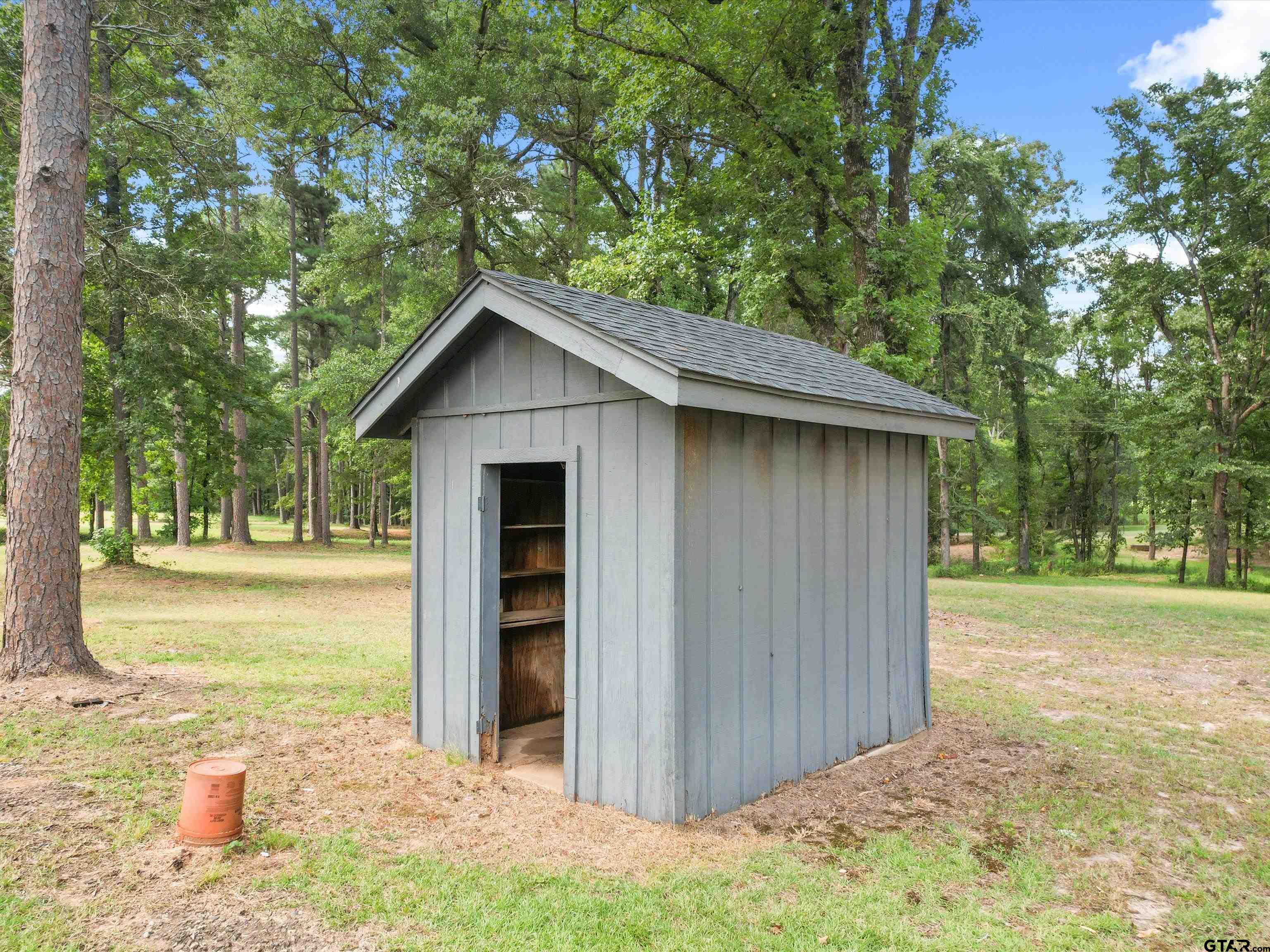 637 County Road 3201 Daingerfield, TX 75638 - Photo 32 of 33 a view of a backyard with large trees and wooden fence