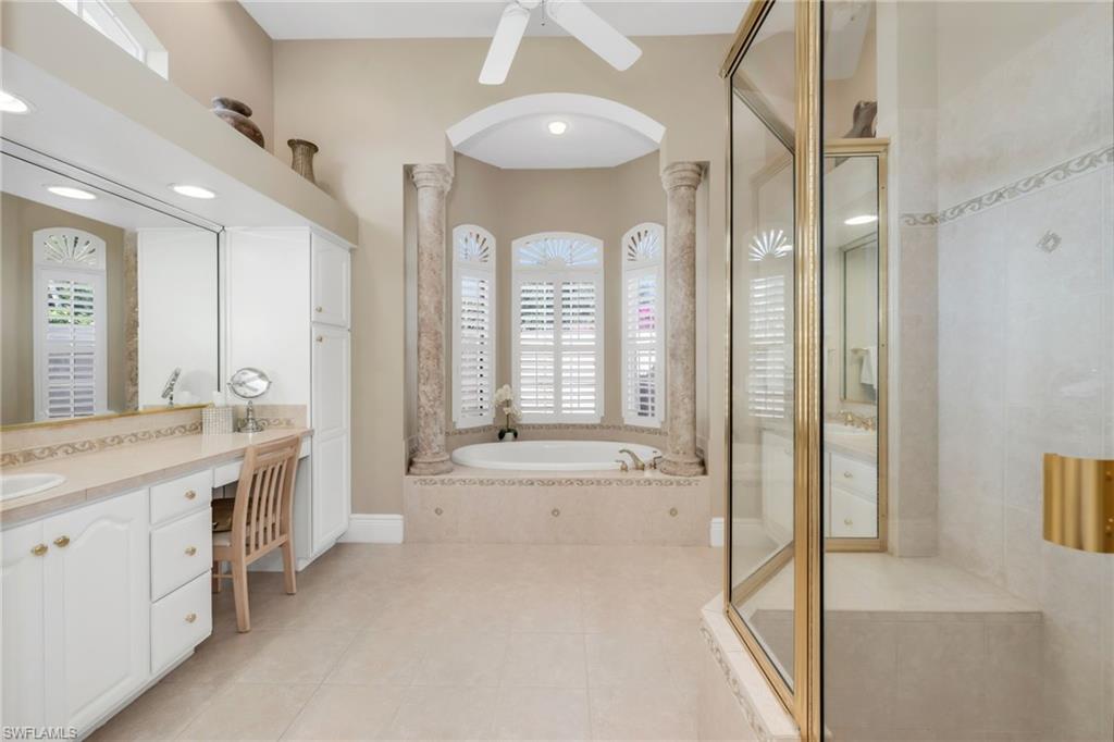 10200 Idle Pine Lane Estero, FL 34135 - Photo 11 of 19 a spacious bathroom with a granite countertop tub sink and mirror