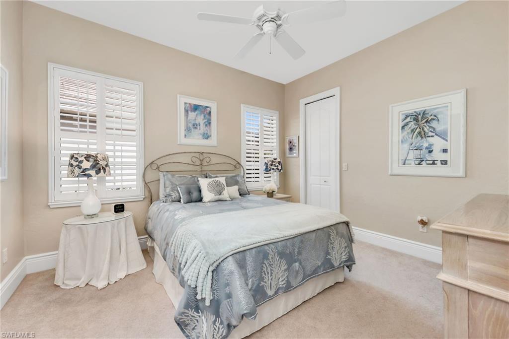 10200 Idle Pine Lane Estero, FL 34135 - Photo 13 of 19 a bedroom with a bed and a painting on the wall