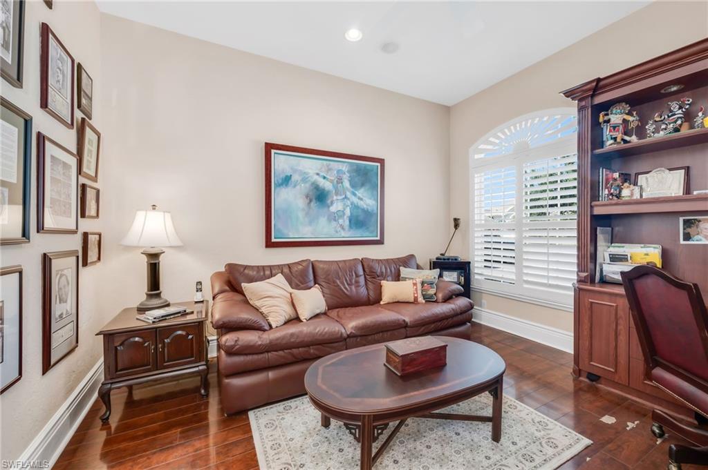 10200 Idle Pine Lane Estero, FL 34135 - Photo 14 of 19 a living room with furniture a rug and a bookshelf