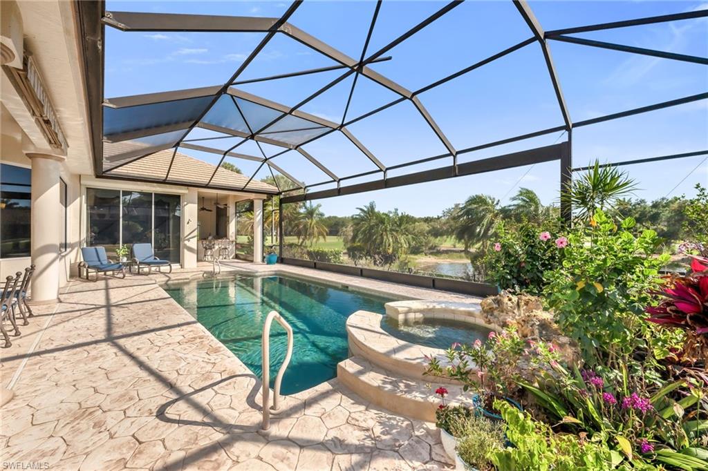 10200 Idle Pine Lane Estero, FL 34135 - Photo 19 of 19 a view of a patio with a table and chairs under an umbrella