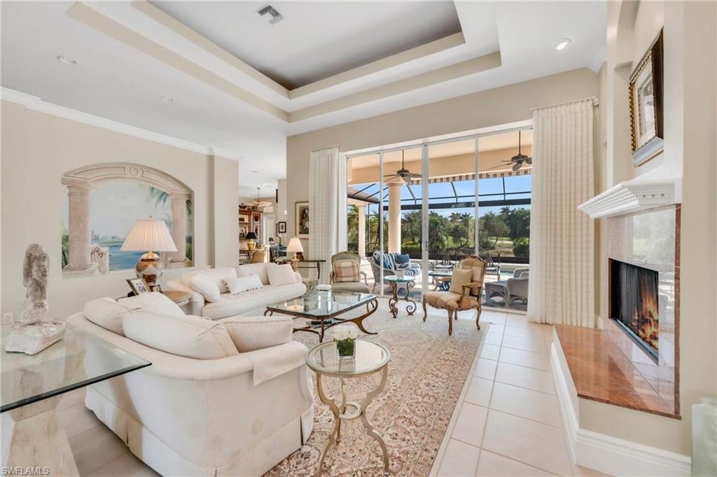 10200 Idle Pine Lane Estero, FL 34135 - Photo 3 of 19 a living room with fireplace furniture and a large window