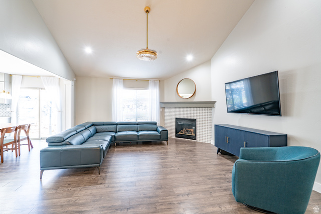 7280 Point Lookout Road Eagle Mountain, UT 84005 - Photo 3 of 26 Living area featuring vaulted ceiling, wood finished floors, a fireplace, and recessed lighting
