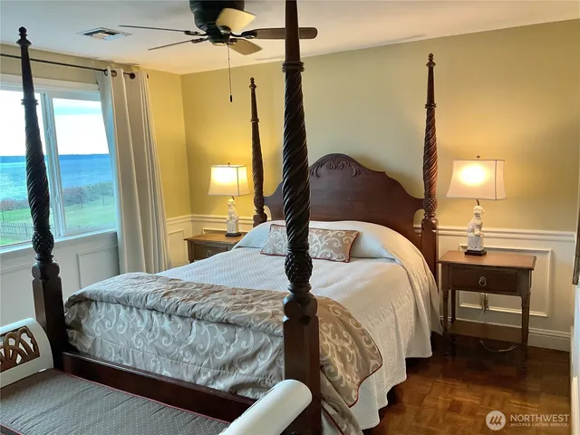a bed sitting in a bedroom next to a window