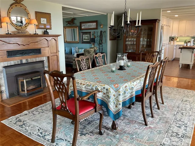 a dining room with a wooden table and chairs