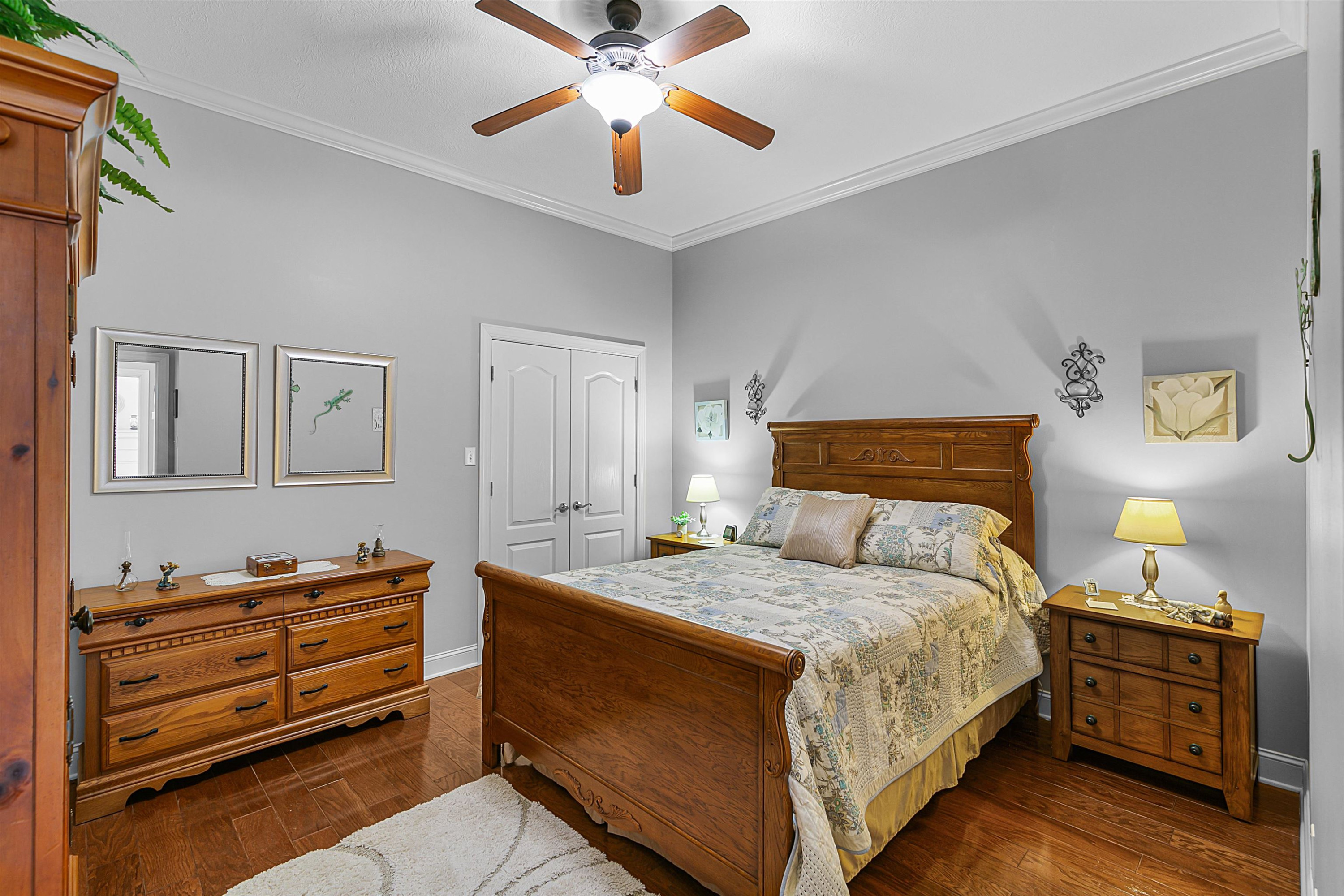 400 Hughes Road East Jackson, TN 38305 - Photo 17 of 36 a bedroom with a bed and wooden floor