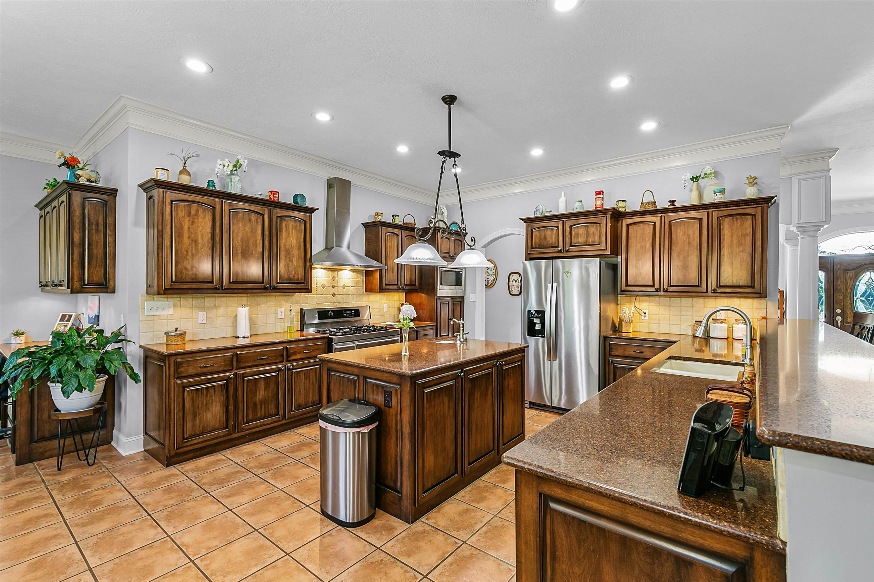 400 Hughes Road East Jackson, TN 38305 - Photo 26 of 36 a kitchen with stainless steel appliances granite countertop a sink stove and refrigerator