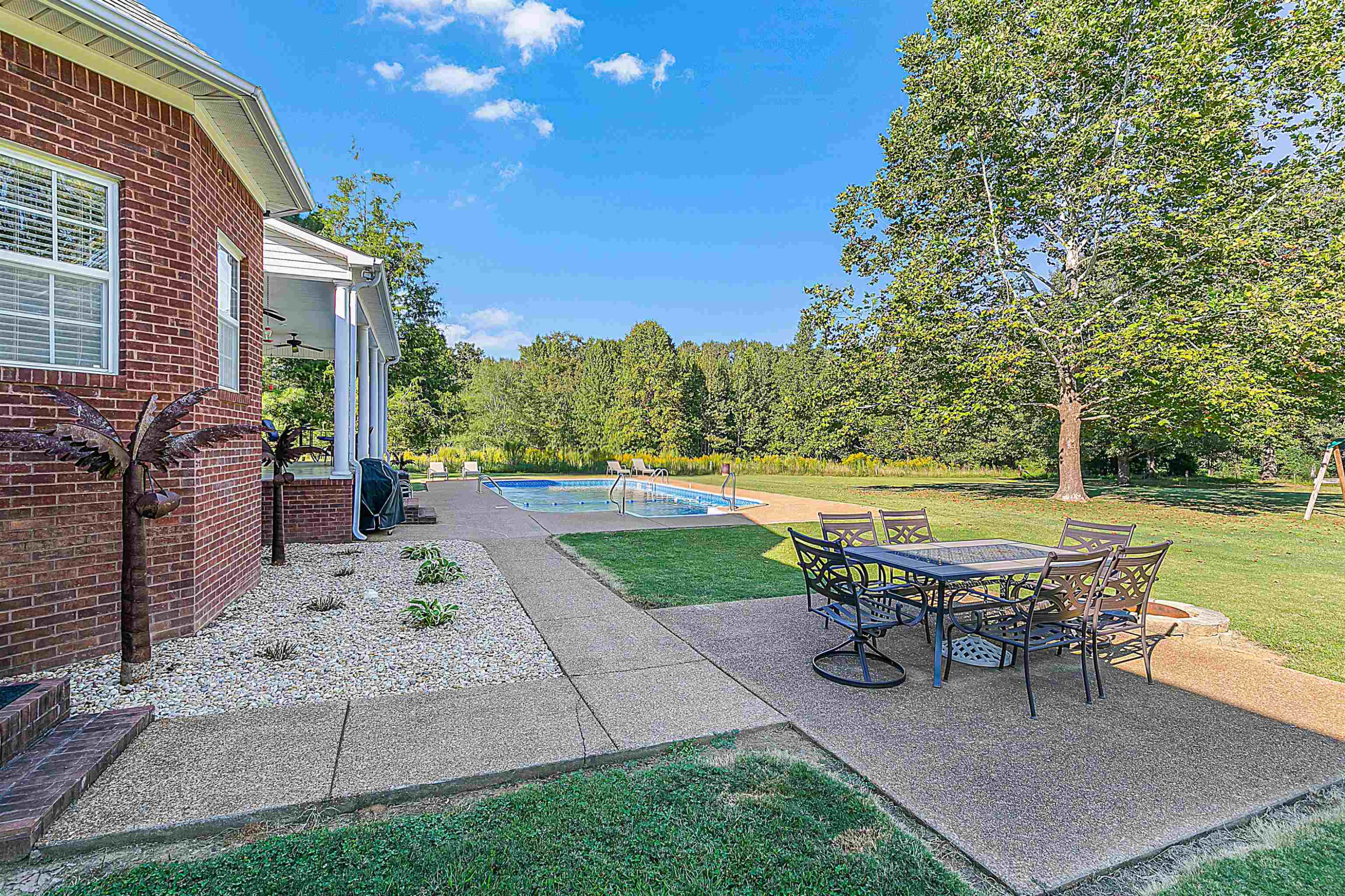 400 Hughes Road East Jackson, TN 38305 - Photo 8 of 36 a swimming pool with outdoor seating and yard