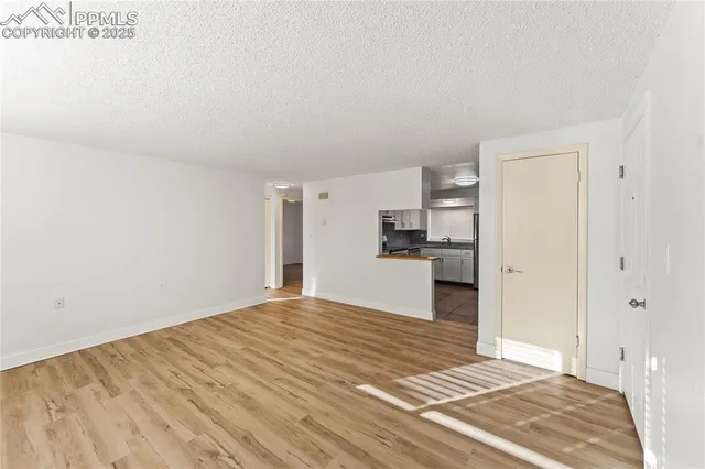a kitchen with white cabinets and appliances