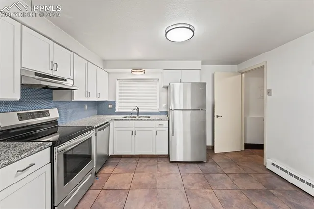 a kitchen with stainless steel appliances granite countertop a refrigerator sink and cabinets