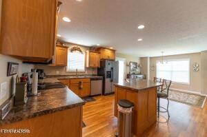 338 Pistole Road Sparta, TN 38583 - Photo 12 of 39 a kitchen with stainless steel appliances granite countertop sink stove top oven and cabinets
