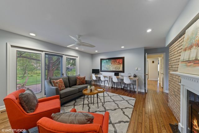 a living room with furniture a fireplace and a flat screen tv