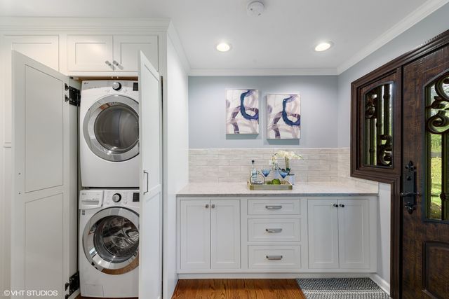 a utility room with sink dryer and washer