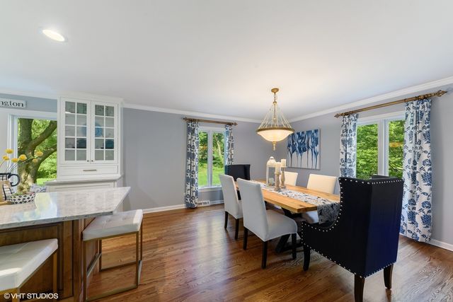 a dining room with furniture a livingroom and wooden floor