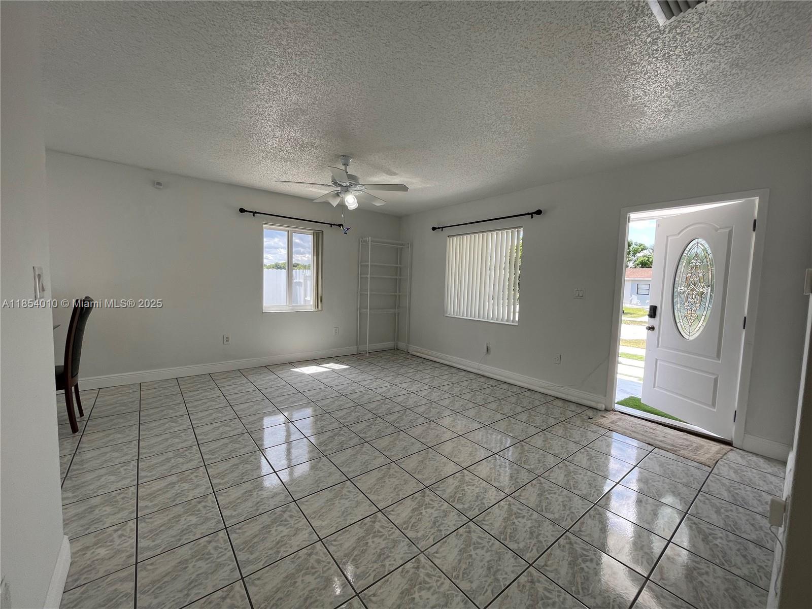 15550 Southwest 308th Street, Unit 15550 Homestead, FL 33033 - Photo 2 of 11 a view of an empty room and window