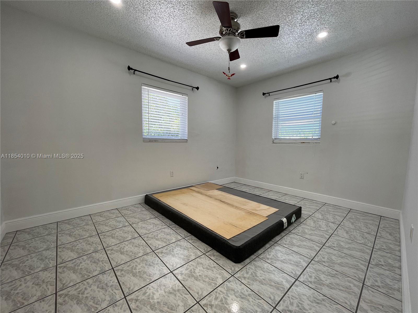15550 Southwest 308th Street, Unit 15550 Homestead, FL 33033 - Photo 9 of 11 a room with pool table and windows