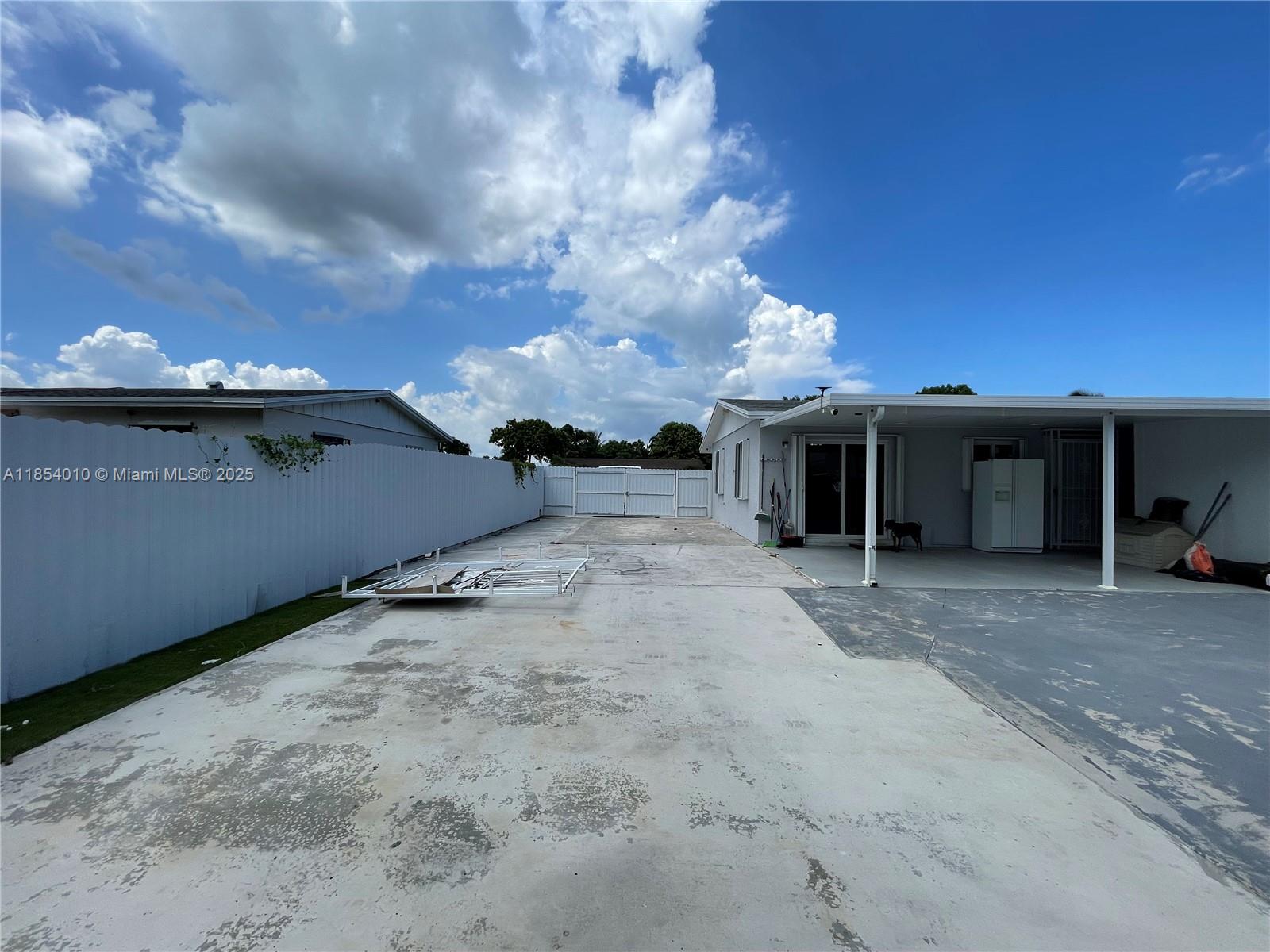 15550 Southwest 308th Street, Unit 15550 Homestead, FL 33033 - Photo 10 of 11 a view of a house with a yard and a large window