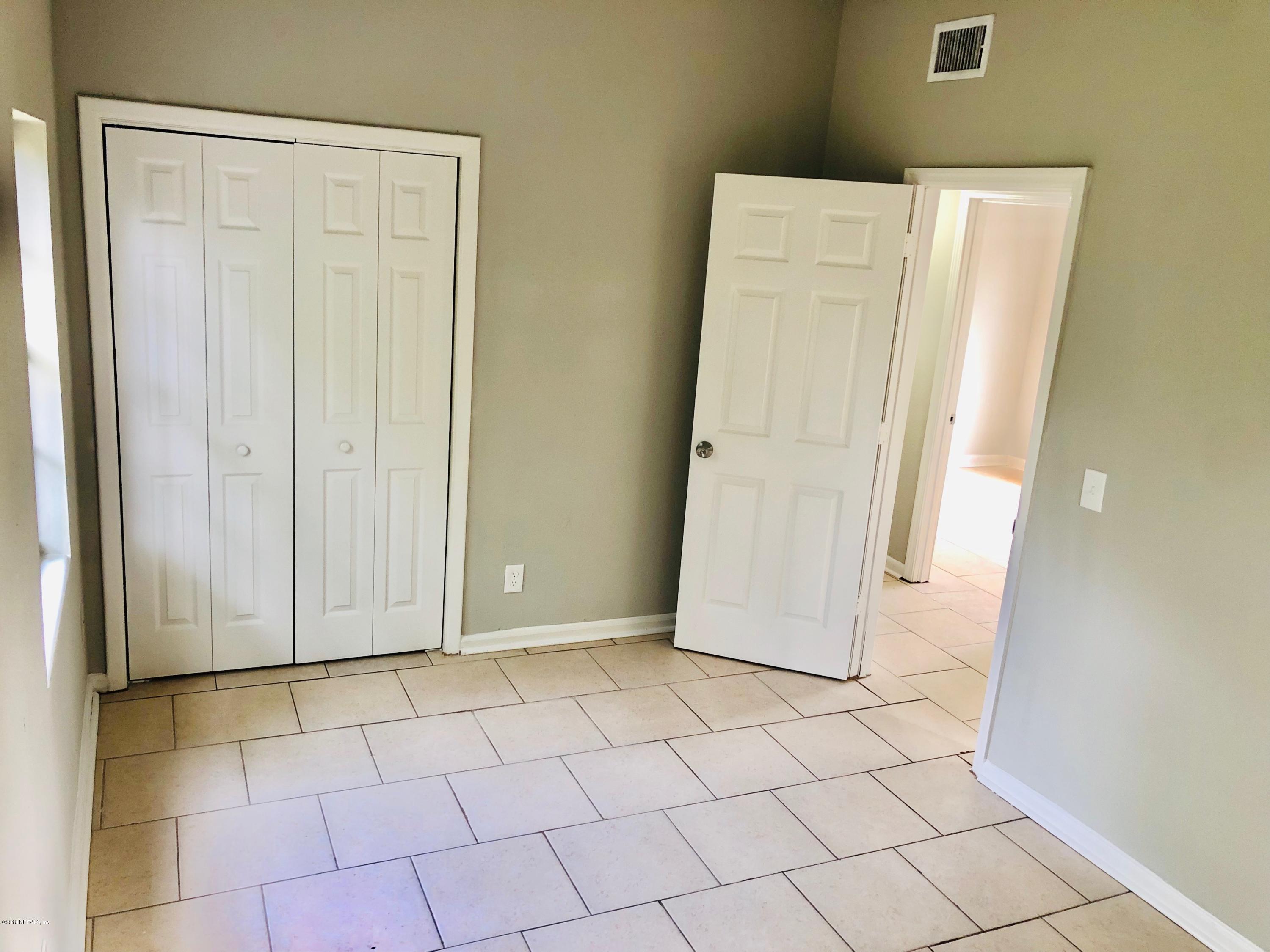 10448 Dodd Road Jacksonville, FL 32218 - Photo 11 of 14 a view of a livingroom with wooden floor