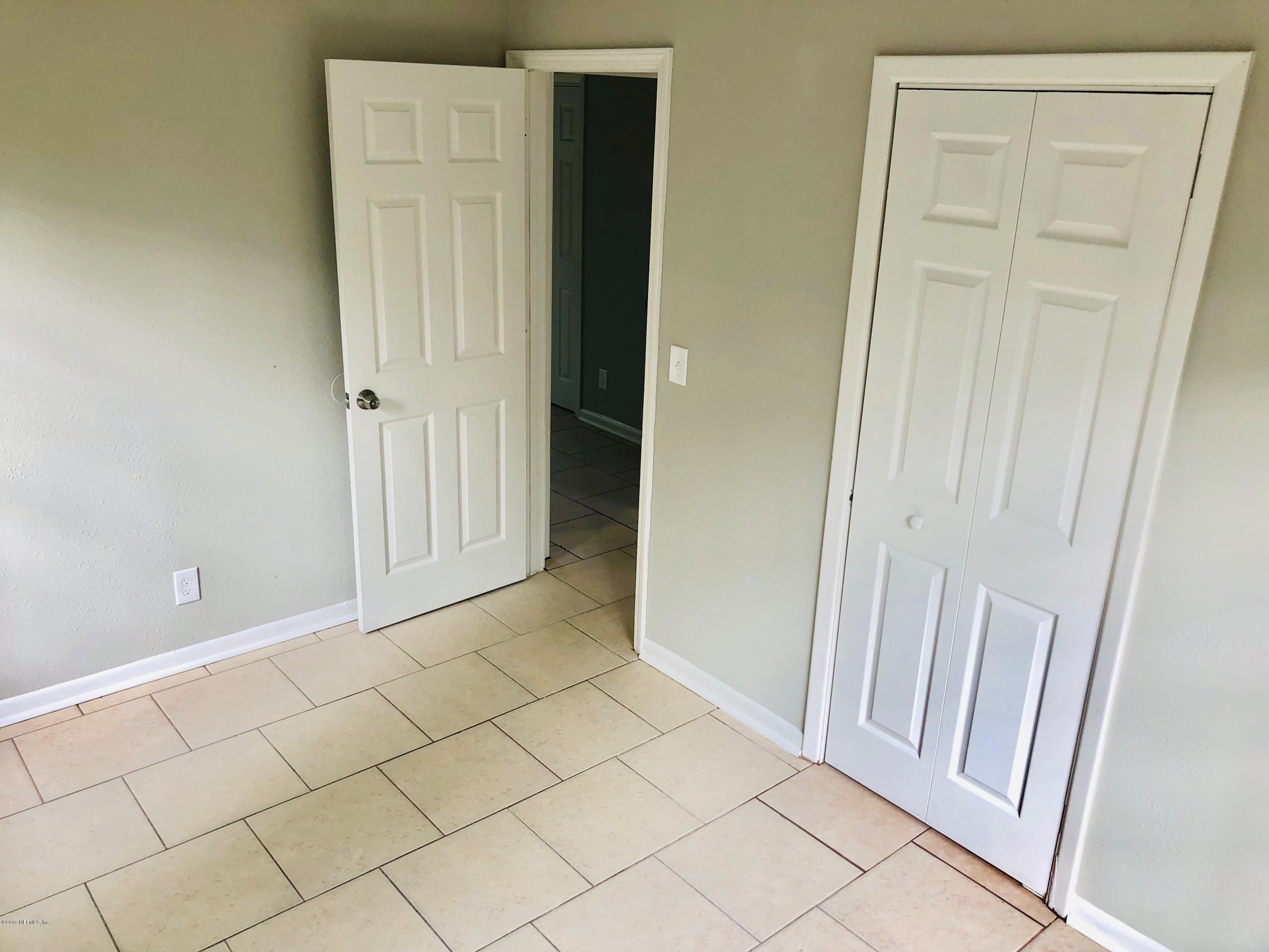10448 Dodd Road Jacksonville, FL 32218 - Photo 10 of 14 an empty room with windows