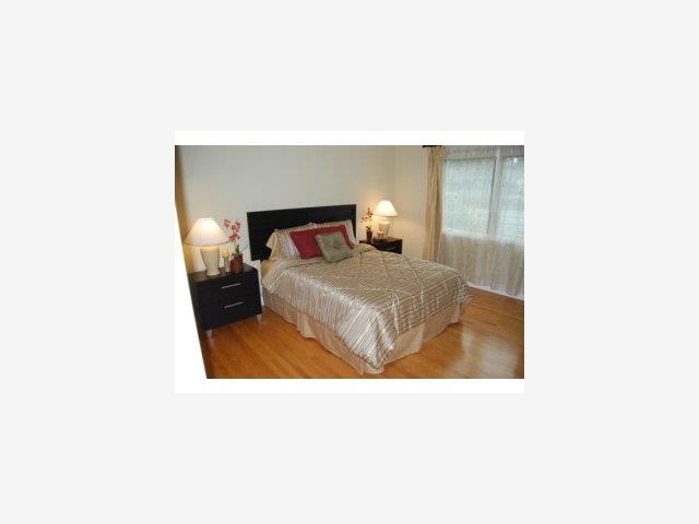 1124 Springer Road Los Altos, CA 94024 - Photo 5 of 9 a bedroom with a bed and a night stand