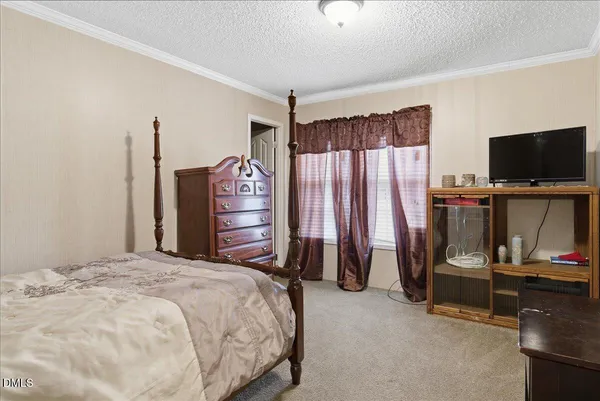 a bedroom with a bed and a mirror