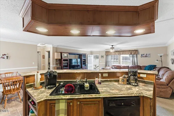a kitchen with stainless steel appliances granite countertop a stove refrigerator and cabinets