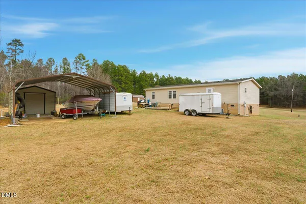a view of a roof deck with table and chairs with wooden floor and fence