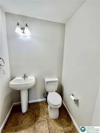 a bathroom with a sink toilet and a mirror