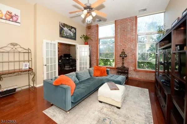 a living room with fireplace furniture and a flat screen tv