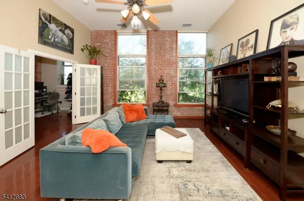a living room with patio furniture and a flat screen tv