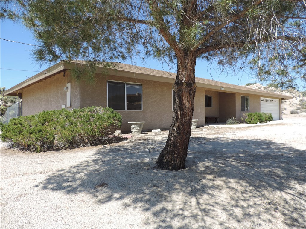5808 San Rafael Road Yucca Valley, CA 92284 - Photo 1 of 1 a front view of a house with a yard and garage