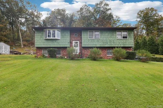 a front view of house with yard and green space