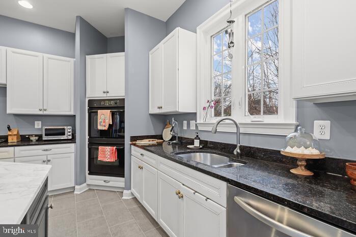 2520 Stone Cliff Drive Baltimore, MD 21209 - Photo 25 of 72 a kitchen with stainless steel appliances granite countertop a sink a stove and a granite counter tops