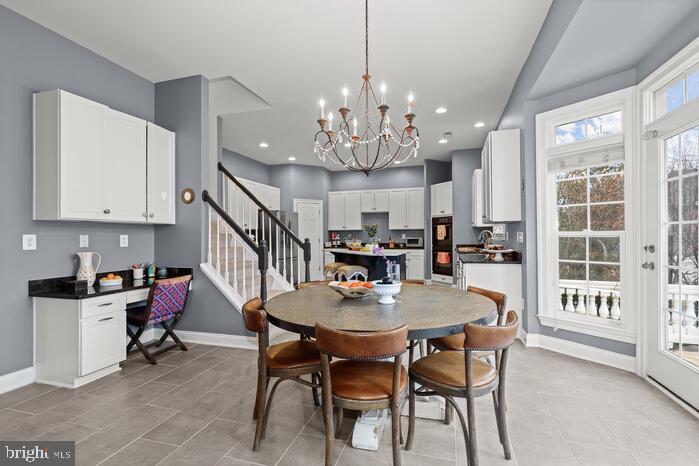 2520 Stone Cliff Drive Baltimore, MD 21209 - Photo 34 of 72 a view of a dining room with furniture and a chandelier