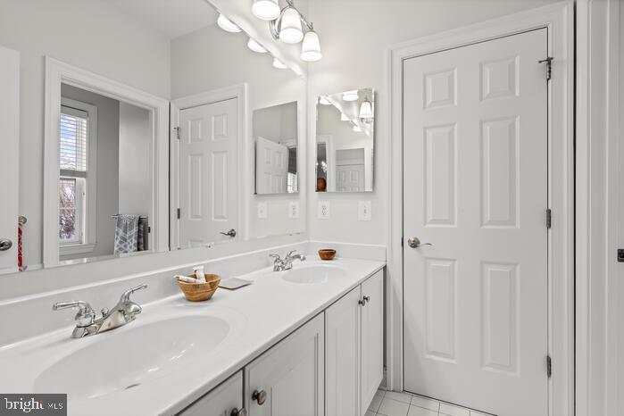 2520 Stone Cliff Drive Baltimore, MD 21209 - Photo 48 of 72 a bathroom with a sink vanity and mirror