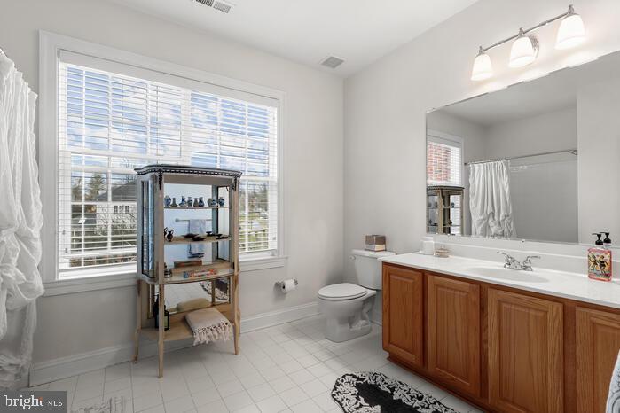 2520 Stone Cliff Drive Baltimore, MD 21209 - Photo 51 of 72 a spacious bathroom with a sink toilet a mirror and shower