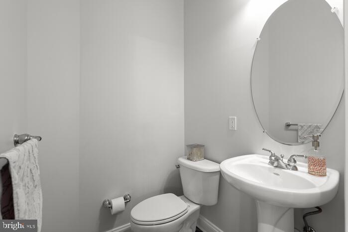 2520 Stone Cliff Drive Baltimore, MD 21209 - Photo 70 of 72 a bathroom with a sink a toilet and mirror