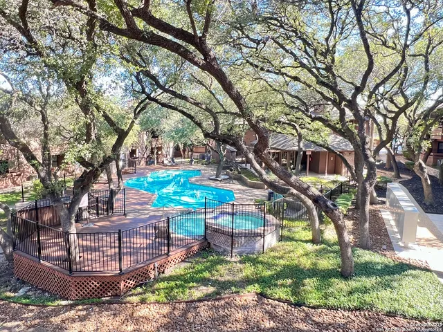 a wooden bench sitting in front of a tree