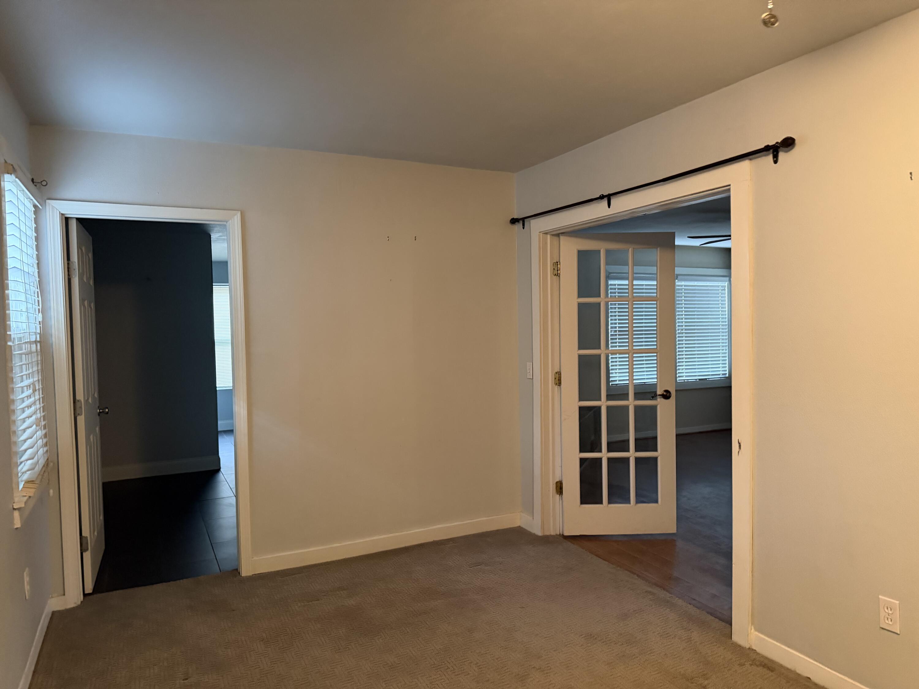 3110 22nd Street Lubbock, TX 79410 - Photo 10 of 22 an empty room with wooden floor and a window