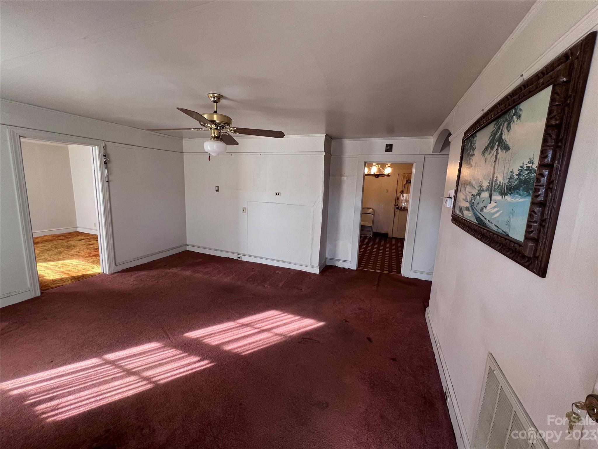 127 River Loop Road Belmont, NC 28012 - Photo 13 of 34 a view of a bedroom with wooden floor and a ceiling fan