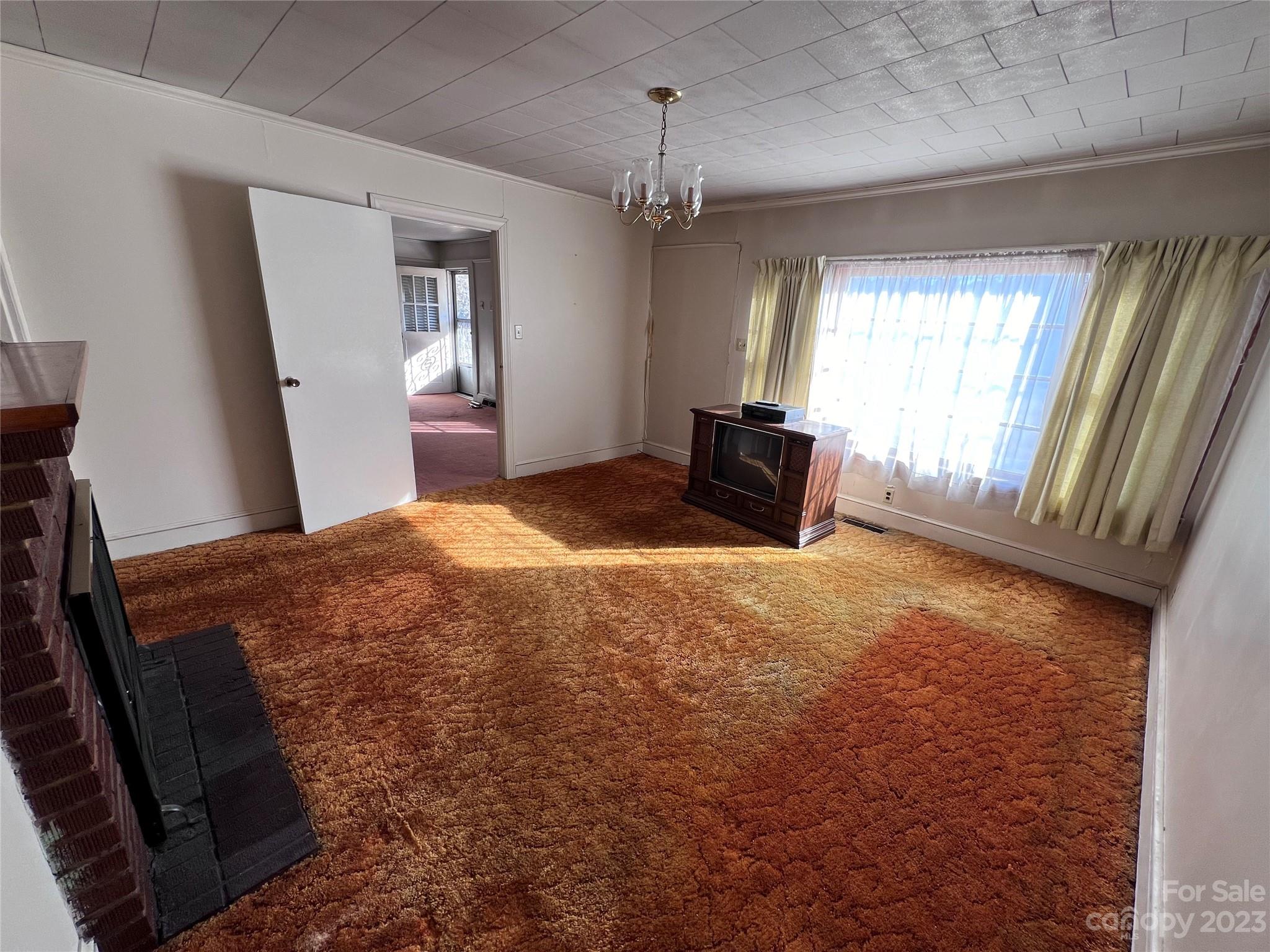 127 River Loop Road Belmont, NC 28012 - Photo 15 of 34 a bedroom with a bed and a chandelier